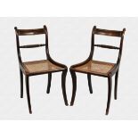 A pair of Regency painted-grain, faux rosewood dining chairs with brass strung label top rail and