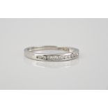 A 9ct white gold and diamond half eternity ring channel set with brilliant cut diamonds, size M½.