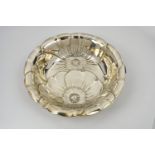 An American silver dish by Wallace & Sons, decorated with embossed overlapping poppy flower