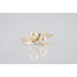 A 9ct yellow gold and pearl ring with two cultured pearls in a twist setting, size N½.