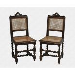 A pair of 19th century Continental carved oak side chairs the square caned backs with foliate carved