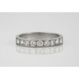 An 18ct white gold and diamond half eternity ring set with nine brilliant cut diamonds, size S.
