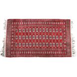 A good quality Bokhara rug the dark madder field with three rows of fourteen gols, within a floral