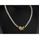 A single strand cultured pearl necklace with 5mm. pearls and 9ct gold pearl set bow clasp, 15in. (