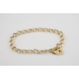 A 9ct yellow gold plain charm bracelet curb link, with heart padlock clasp.