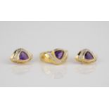An 18ct gold, amethyst and diamond ring and stud earrings en suite each with a triangular cut