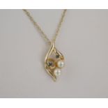 A 9ct gold, sapphire and pearl pendant the leaf shaped openwork pendant set with two round cut