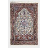 An Isfahan silk prayer rug the ivory field with central eight pointed star medallion amidst