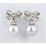 A good pair of 18ct white gold, South Sea pearl and diamond drop earrings the 15mm. pearls on