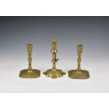 A closely matched pair of George I cast brass candlesticks with tapered cylindrical nozzles,