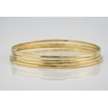 A set of four 9ct plain gold bangles made by Neville Paint. (4)