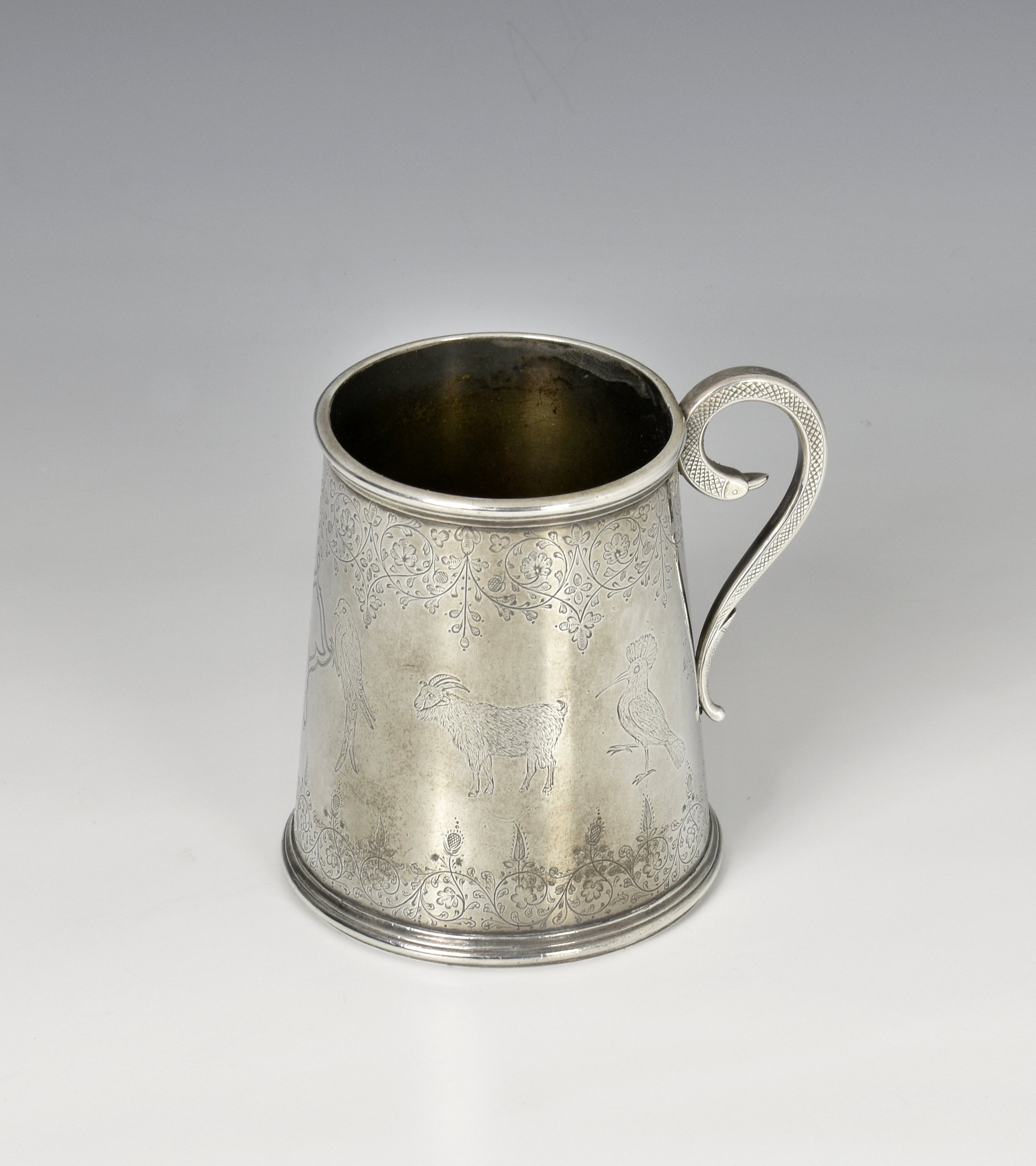 A late 19th century Indian silver tankard tapered cylindrical form, finely engraved with wildlife