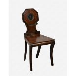 A Regency mahogany hall chair the octagonal back with reeded border, centred by a roundel with