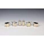 A George V silver six piece cruet set Henry Atkins, Sheffield 1916, oval form with blue glass