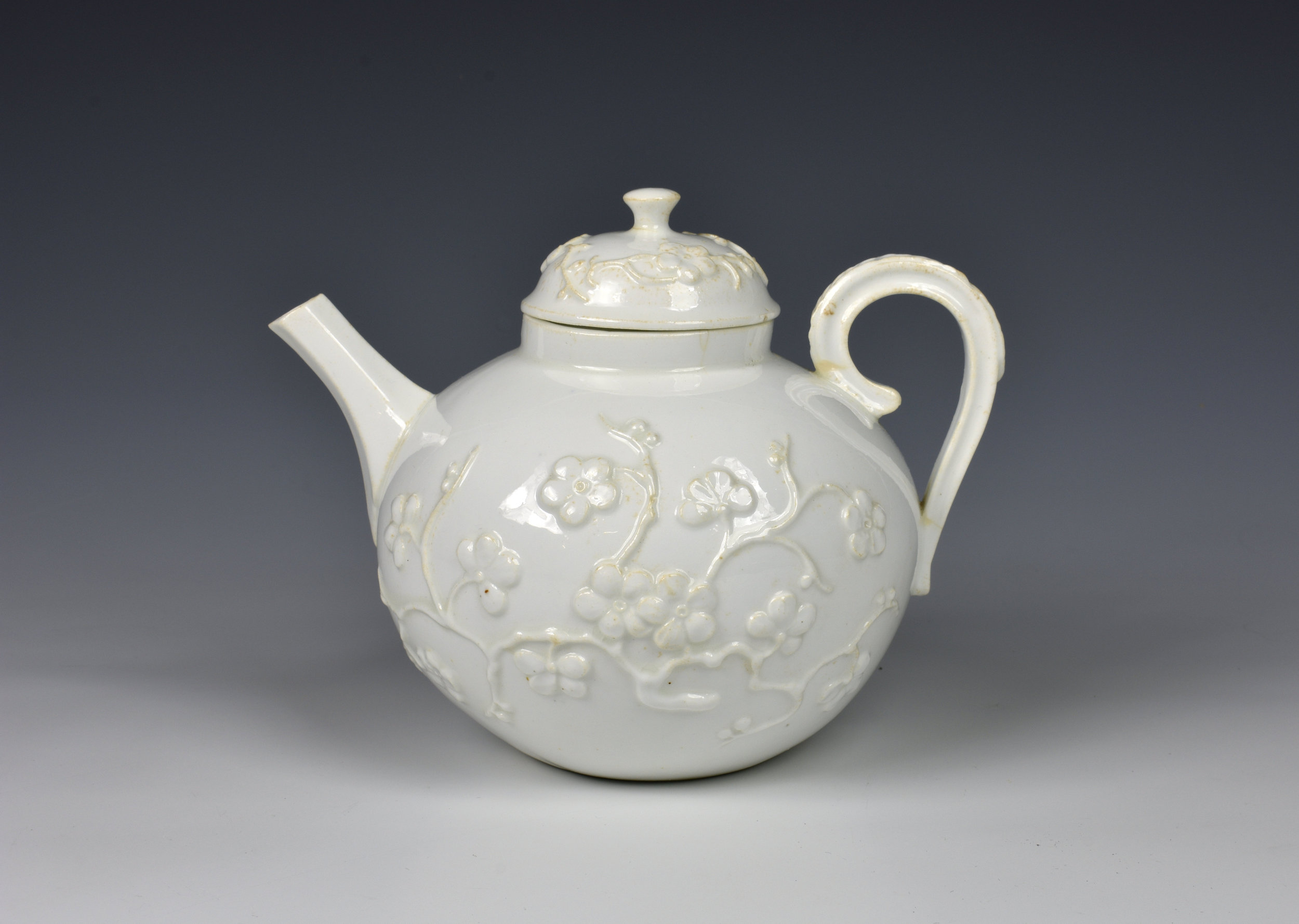 An 18th century porcelain blanc-de-chine teapot possibly Saint-Cloud, c.1740, the globular teapot