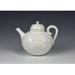 An 18th century porcelain blanc-de-chine teapot possibly Saint-Cloud, c.1740, the globular teapot