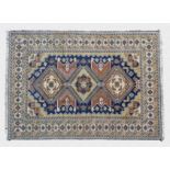 A Shirvan rug mid-20th century, the triple hooked lozenge medallions on a Royal blue field with