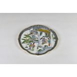 A late 19th century Chinese porcelain shaped oval, shallow dish decorated with scholars in a house