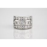 A fine 18ct white gold and diamond ring set with three rows of princess and brilliant cut
