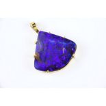 An 18ct yellow gold and black opal pendant hallmarked London 2004, with a 24 x 22mm. fan shaped