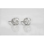 A pair of 18ct white gold and diamond stud earrings the old brilliant cut diamonds with cut