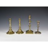 A pair of George II brass candlesticks c.1750, the octagonal waisted sconces and tapered stems on