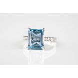 An 18ct white gold, aquamarine and diamond ring the 4.45ct emerald cut aquamarine above diamond