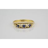An 18ct gold, sapphire and diamond five stone ring early 20th century, with three graduated round