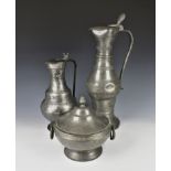 A large 18th century French pewter pitcher or flagon of waisted form with long ribbed neck, scroll