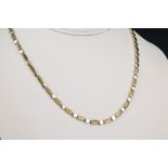 A 9ct two colour gold necklace and bracelet set with alternate burnished yellow and polished white