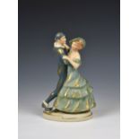 An Art Deco Royal Dux figure of Pierrot dancing with a lady with gold painted highlighting, on an