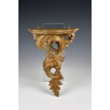 An 19th century carved limewood rococo style foliate wall bracket traces of gilding to reverse, with