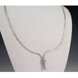 An 18ct white gold and diamond fringe necklet the polished curved links joined at the drop with