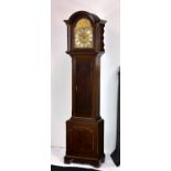 A late Victorian eight day longcase clock the eight day movement striking the hours on a gong,