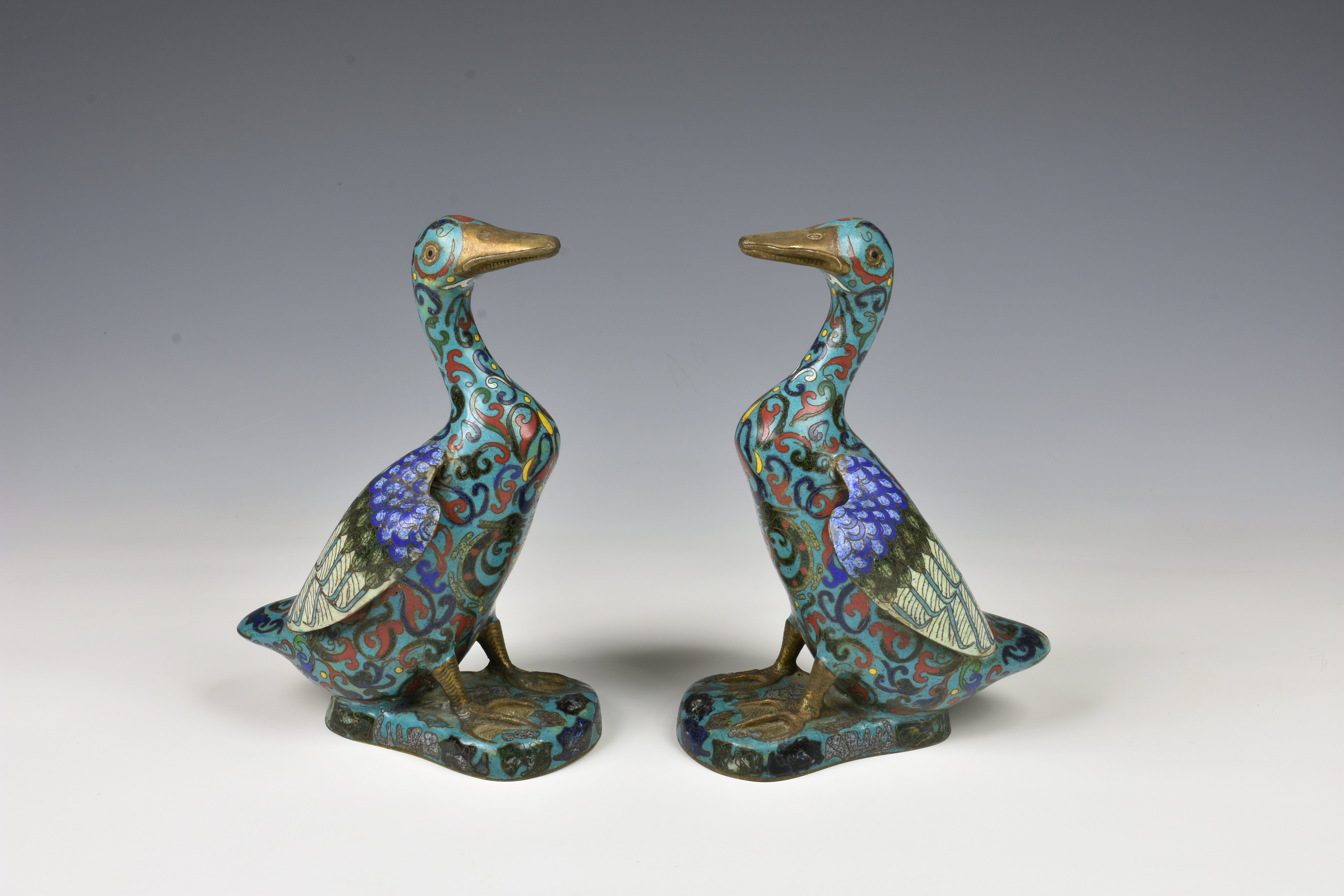 A pair of Chinese cloisonne figures of ducks probably early 20th century, in polychrome enamels on a