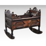A large Continental oak, fruitwood and marquetry rocking cradle 19th century, the pierced scrollwork
