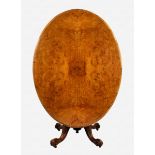 A Victorian burr walnut tilt-top breakfast table the oval, quarter veneered top on a vase turned