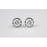 A fine pair of 18ct white gold and diamond solitaire stud earrings by Andrew Geoghegan the brilliant