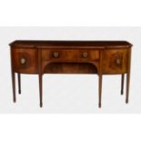 An Edwardian inlaid mahogany break bowfront sideboard by Spillman & Co. of London with stained