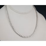 A fine 18ct white gold and diamond graduated line necklace the brilliant cut diamonds totalling 11.