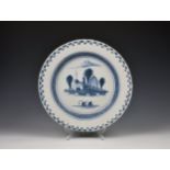 A Dutch Delft charger late 18th / 19th century, tin glazed and painted in blue and white with two