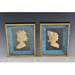 A pair of French cased, carved wax silhouette busts of ladies in 18th century dress and