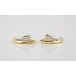 A pair of 18ct yellow gold and diamond stud earrings the split settings each with five graduated