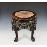A Chinese carved hardwood low jardinière stand late 19th, early 20th century, with inset shaped