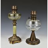 A Victorian gilt metal alabaster oil lamp having a alabaster column to shaped cast metal base, the