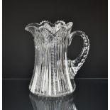 An early 20th century American fine quality cut glass water jug of ribbed design, with crosshatch