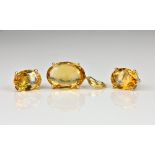 A 14ct yellow gold and citrine pendant and stud earrings en suite with oval cut citrines, the