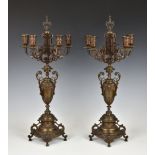A pair of patinated bronze Baroque style five light candelabra late 19th century, mid-brown
