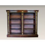 A late Victorian mahogany and ormolu open bookcase in the Louis XVI taste, the ogee moulded top over