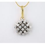 An 18ct white gold and diamond cluster pendant the domed pendant set with twenty four brilliant